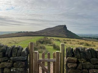 fence along stone. wall pointing to hen cloud