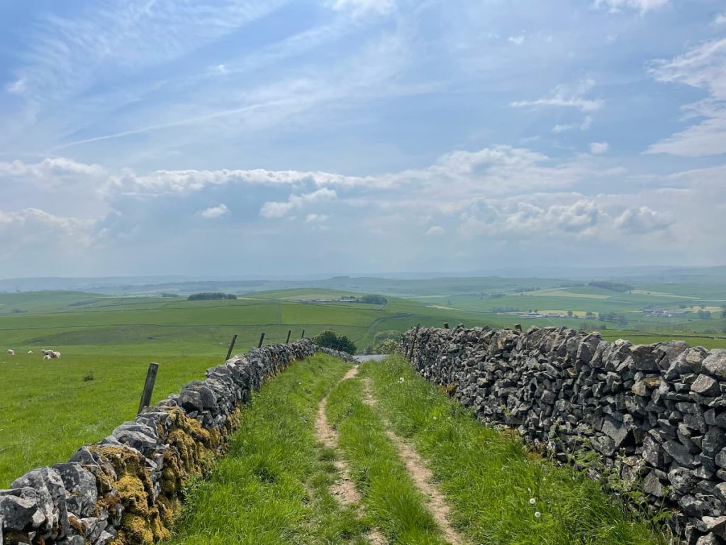 two walls along side the limestone way footpath with an incredible view in the background