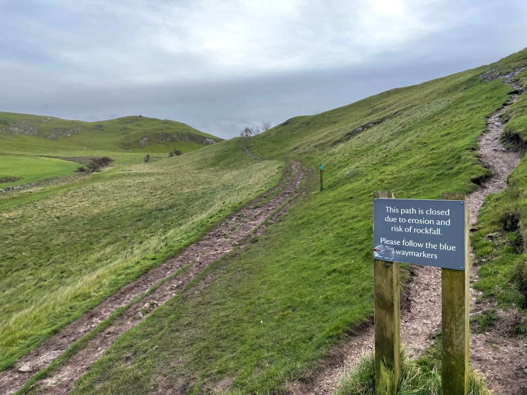 path erosion sign warning people to keep to official thorpe cloud path
