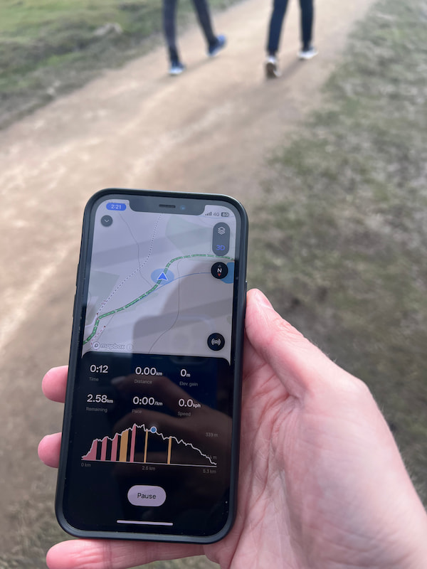 alltrails hiking app in hand